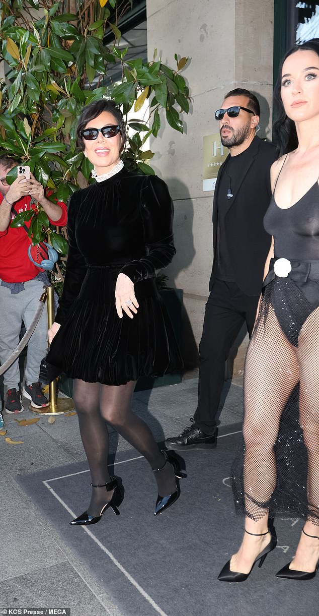 Kris cut a stylish figure in a black long-sleved mini dress