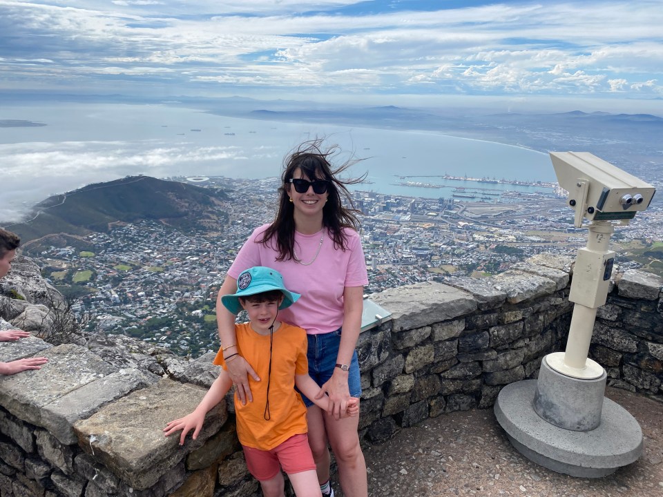 Woman and child overlooking Cape Town from a mountaintop.