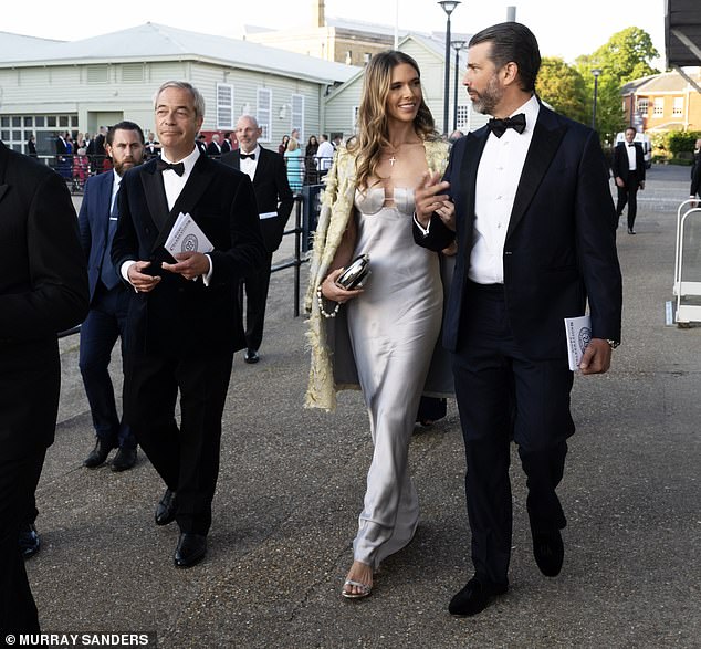 Wearing a dark suit, Donald Trump Jr proudly strode along the streets of Portsmouth, arms linked with his Palm Beach socialite girlfriend Bettina Anderson, earlier this evening