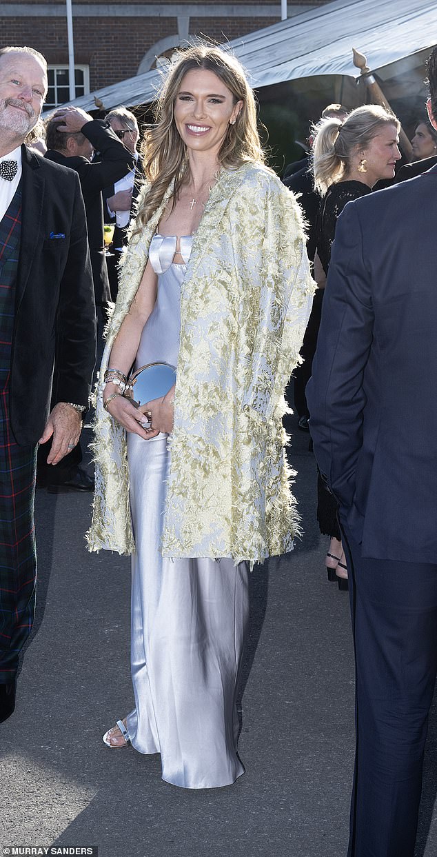 Ms Anderson, who was first seen locking lips with Don Jr . in September, sported a grey maxi satin dress, with a yellow jacket with accents of blue draped over her shoulders
