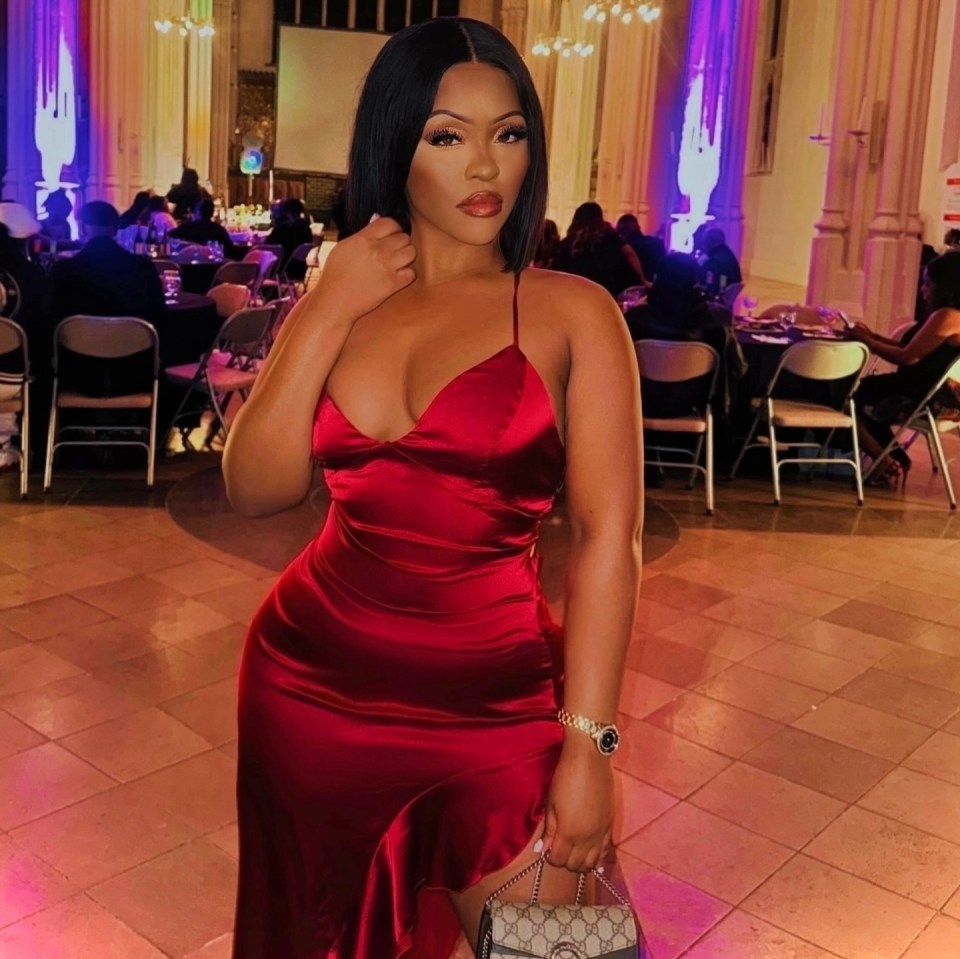 Woman in red satin dress at an event.