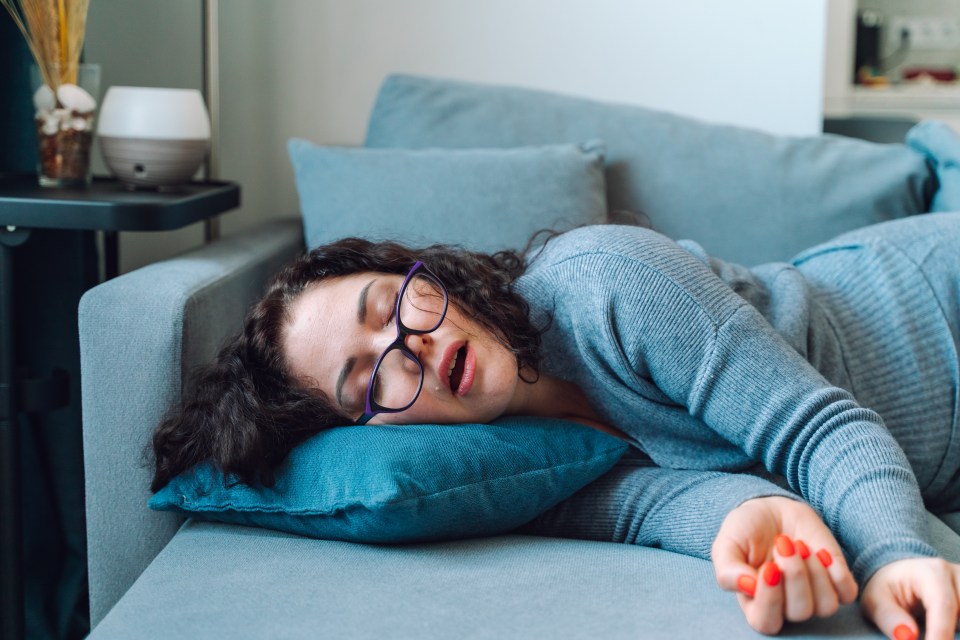 Woman sleeping on a couch.