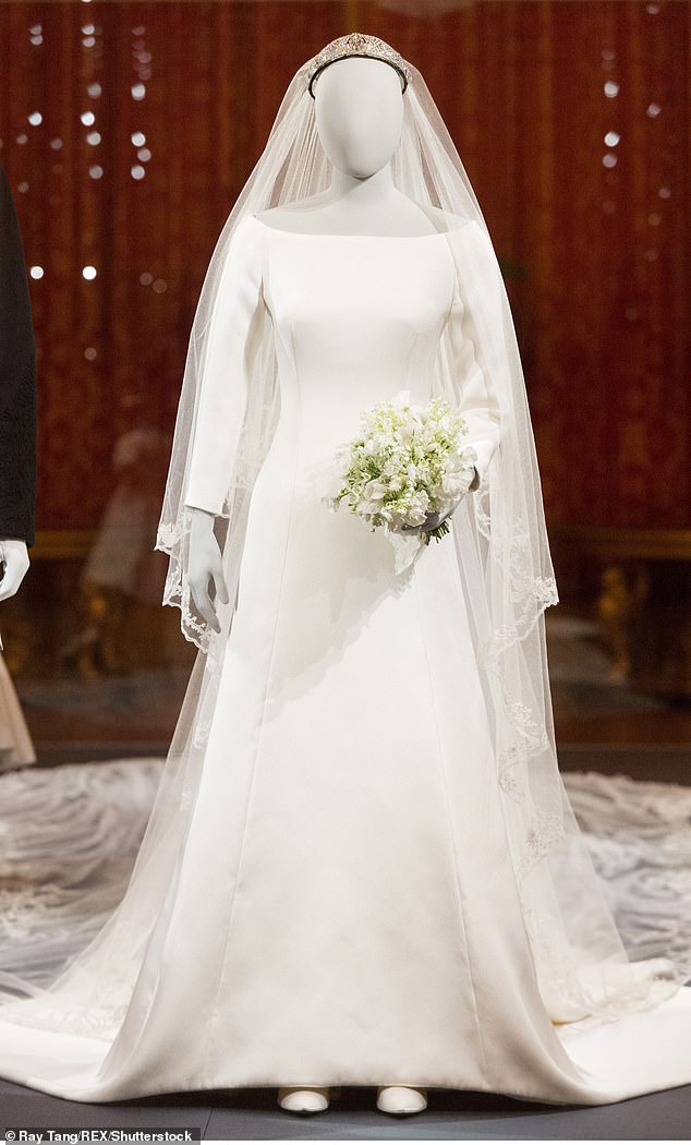 Meghan's wedding dress is pictured at The Royal Collection at Windsor Castle 'A Royal Wedding: The Duke and Duchess of Sussex' exhibition in October 2018