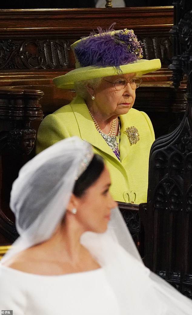 On the day of the wedding, staunch royal observers noticed the Queen's face looked stern as she looked across at Meghan in her wedding dress