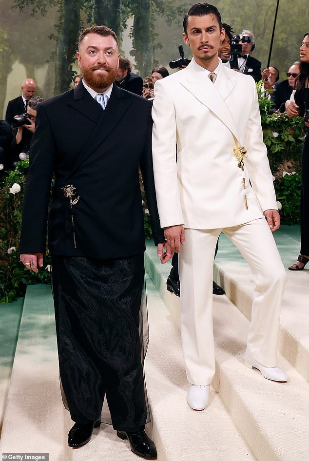 Sam Smith was reportedly turned away from a 2024 Met Gala afterparty - despite the fact they were staying in the same hotel (pictured at the gala with boyfriend Christian Cowan)