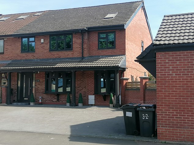 The 'garage' is located on the drive of their semi-detached house in rundown Highgate