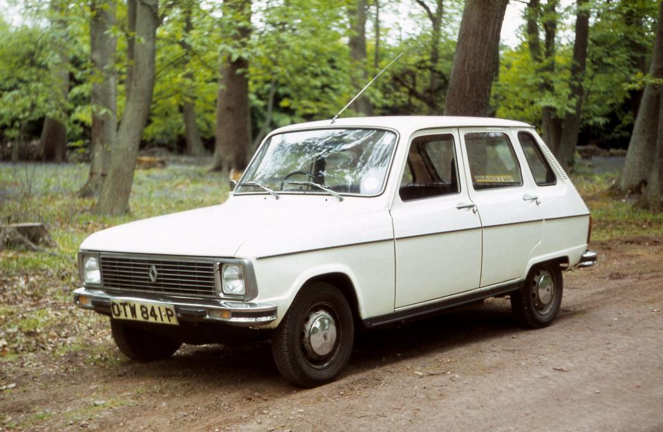 White Renault 6 in a forest.