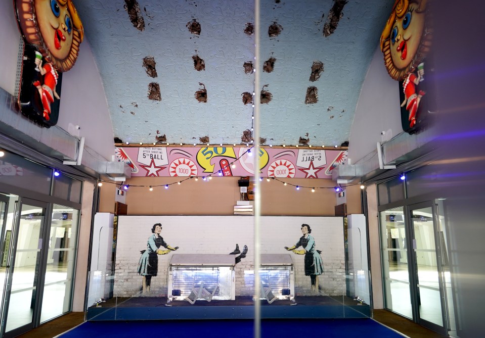 Banksy's Valentine's Day Mascara artwork reflected in a mirror.