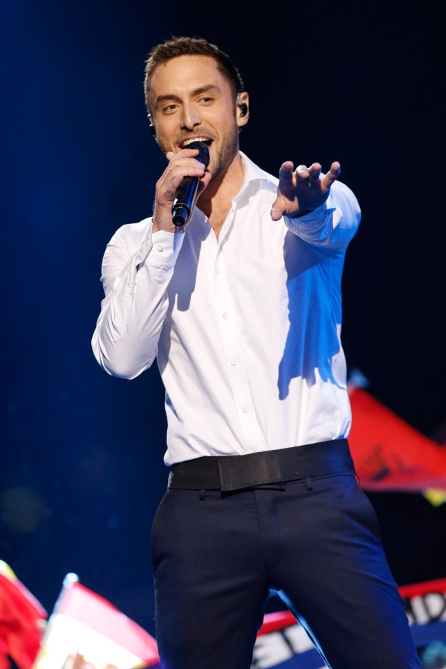 Mans Zelmerlöw performing on stage.