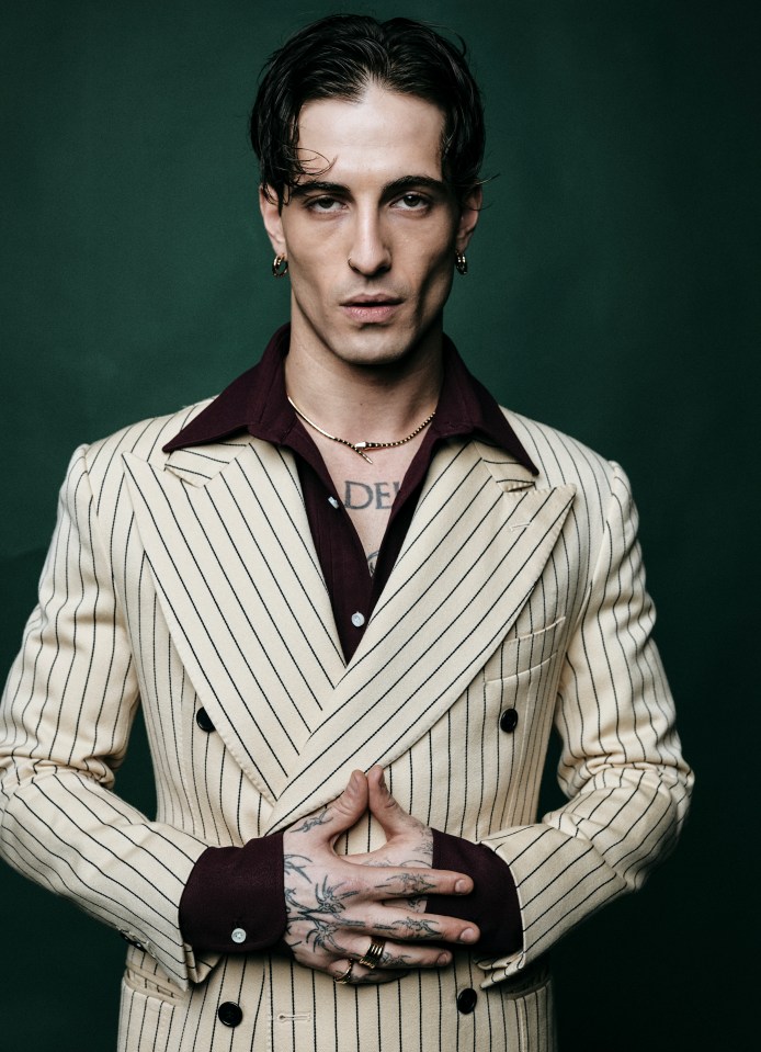 Portrait of Damiano David in a pinstripe suit.