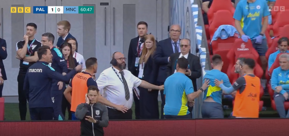 A soccer game's sideline altercation between coaches and players.