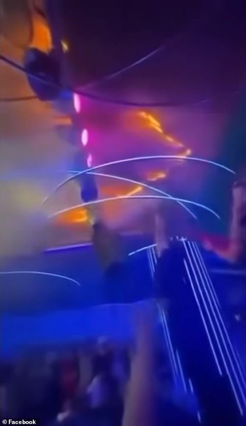 Flames rapidly spread across the ceiling of the nightclub as terrified concertgoers watch on