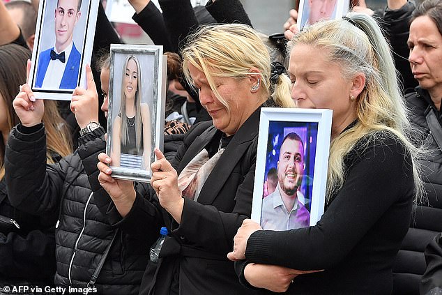 Three women clutch framed photographs of those they lost in the horrific nightclub fire