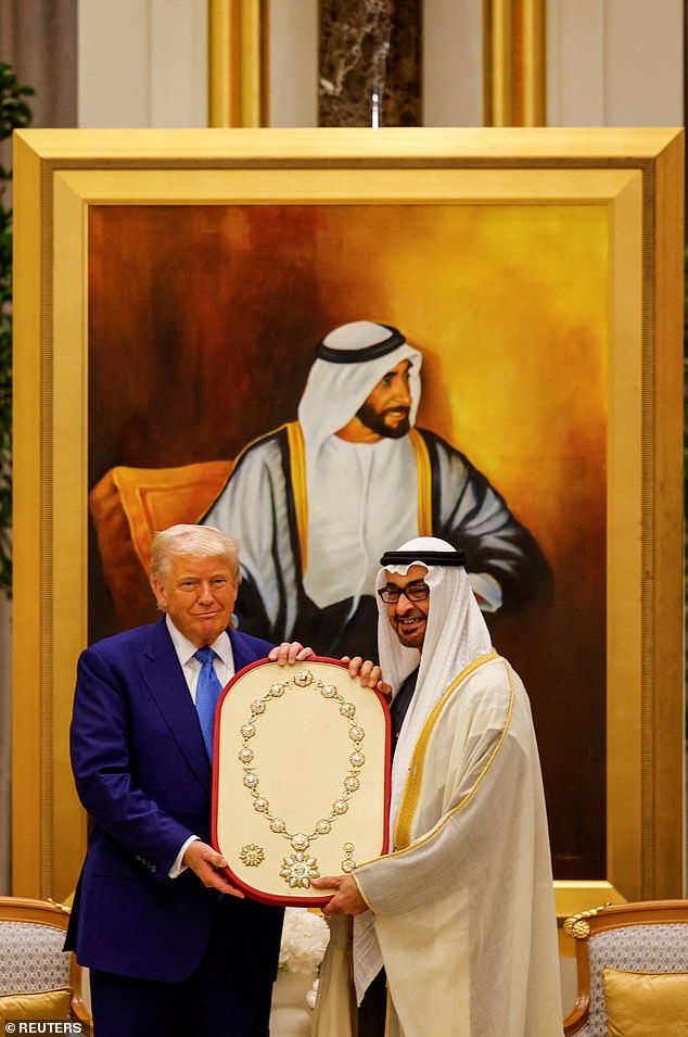 President Donald Trump is given an Order of Zayed medal from UAE President Sheikh Mohamed bin Zayed Al Nahyan at Qasr Al Watan during a state visit Thursday night