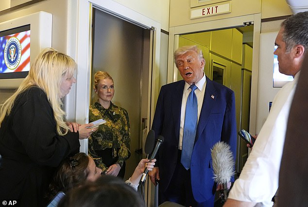 President Donald Trump speaks with reporters on board Air Force One at the conclusion of his three country swing to the Middle East on Friday
