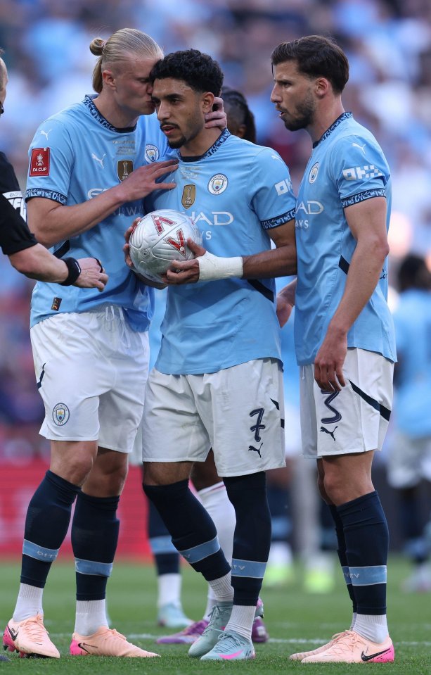 Manchester City players preparing for a penalty kick.