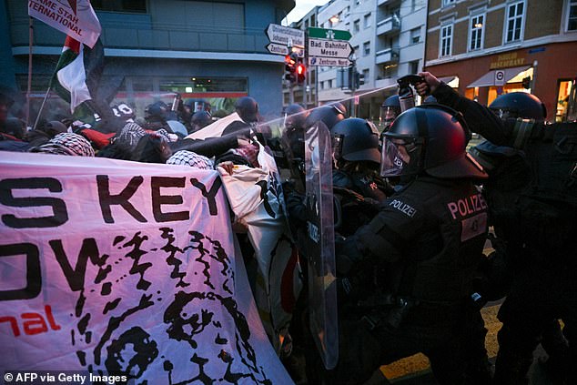 Riot police officers used pepper spray to restrain activists during a pro-Palestine protest outside the Eurovision grand final this evening