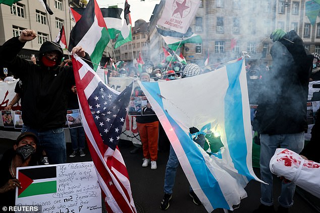 Pro-Palestinian demonstrators burn representations of the U.S. and Israeli flags