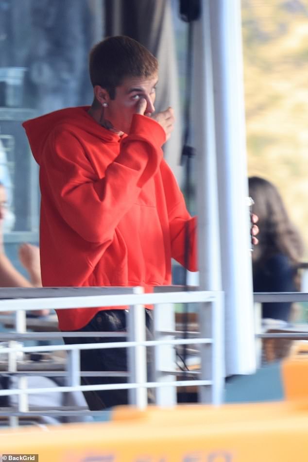 The singer was seen wiping something from his eye
