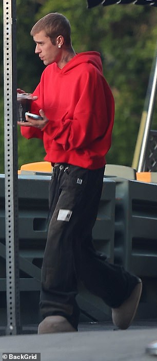He balanced a coffee in his other hand
