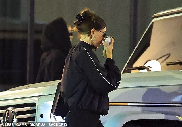 Hailey's outfit included a large handbag and a set of hoop earrings