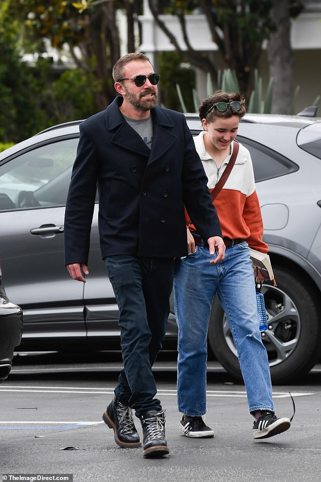 Ben sported a black peacoat with matching jeans and boots for the outing. Peeking out from underneath his coat was a grey t-shirt