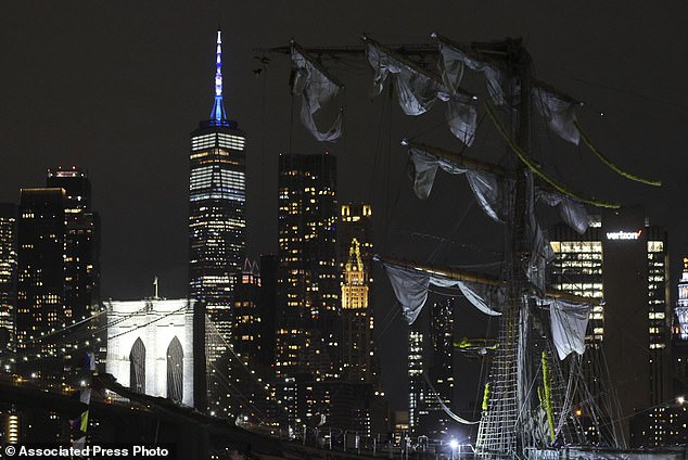 The New York skyline and Brooklyn Bridge are framed in one of the snapped masts of a Mexican Navy training ship after it collided with the Brooklyn Bridge