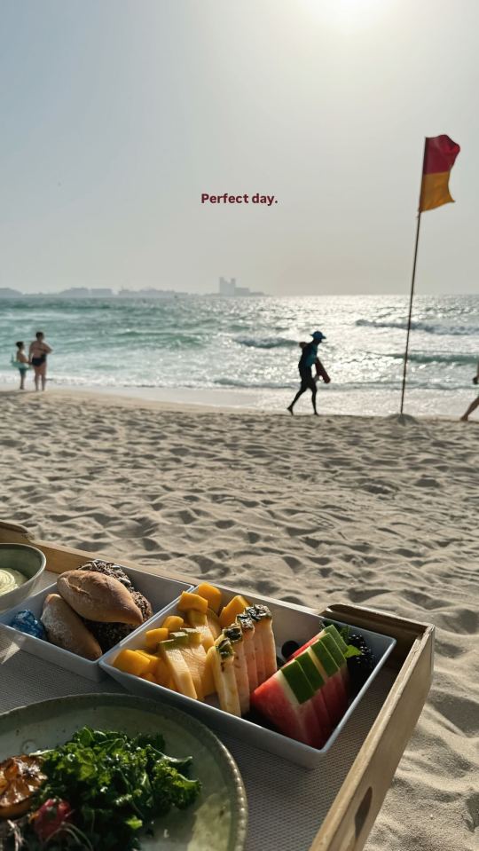 Beach picnic with fruit and bread.
