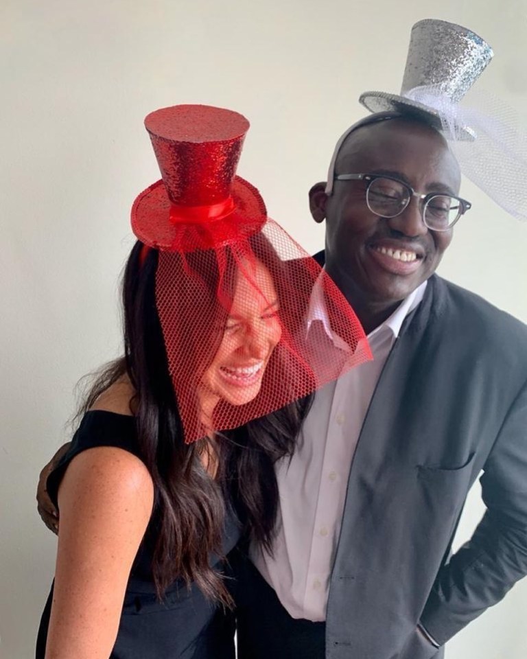 Meghan Markle and Edward Enninful wearing whimsical hats.