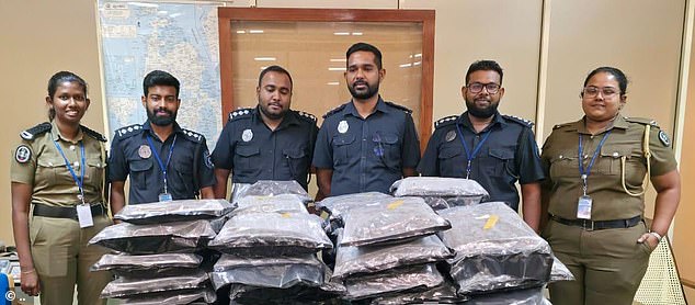 Pictures from the scene show six officers in the airport standing over dozens of large vacuum packed bags of the drug