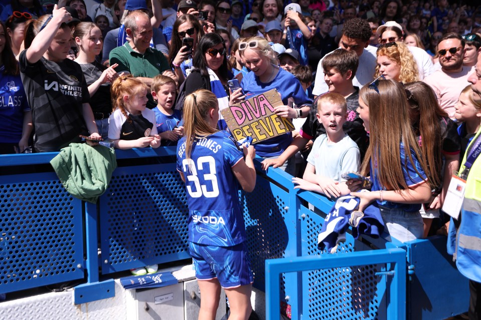 Chelsea FC player Aggie Beever-Jones gives a shirt to a fan.