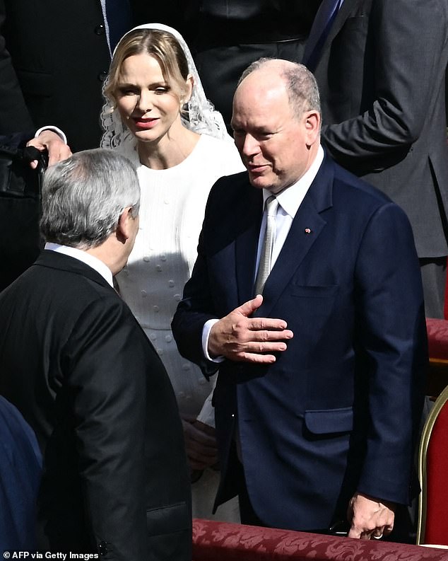 Charlene put on an elegant display in a sophisticated white dress and floral-patterned net veil on Sunday
