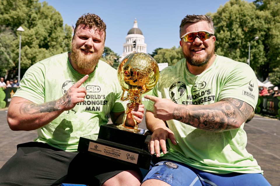 The Stoltman brothers, Tom and Luke, World's Strongest Man champions, holding their trophy.