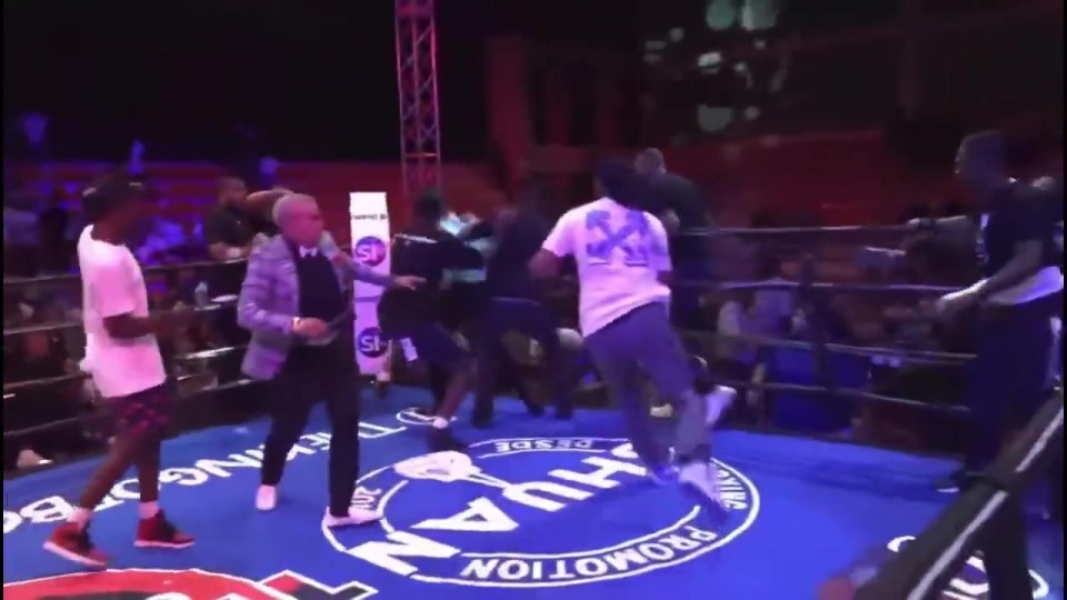 Boxing referee attacked in the ring by several men.