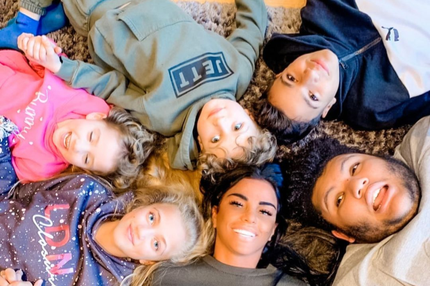 Family lying on the floor in a circle.