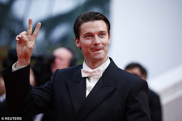 White Lotus star Patrick Schwarzenegger poses on the red carpet during arrivals