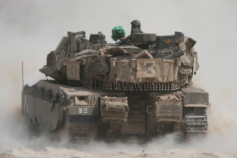 Israeli soldiers operating a tank near the Gaza Strip border.