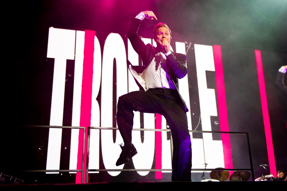 Olly Murs performing on stage.