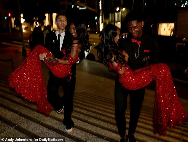 Jessie and D'Lila, 17, were pictured being swept off their feet - quite literally - as their handsome dates carried the glamorous teens who were wearing matching glitzy red gowns