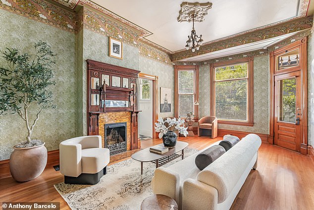 Richly colored formal living room with original woodwork and bay windows