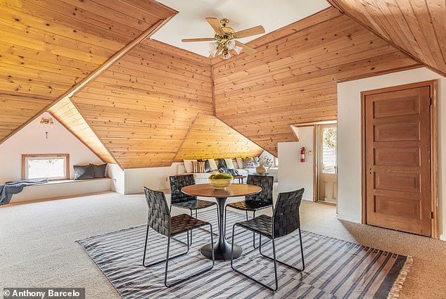 A second attic space that functions as an artist’s retreat or loft