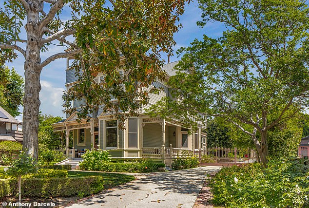 Rear view of the home with lush greenery and private seating areas