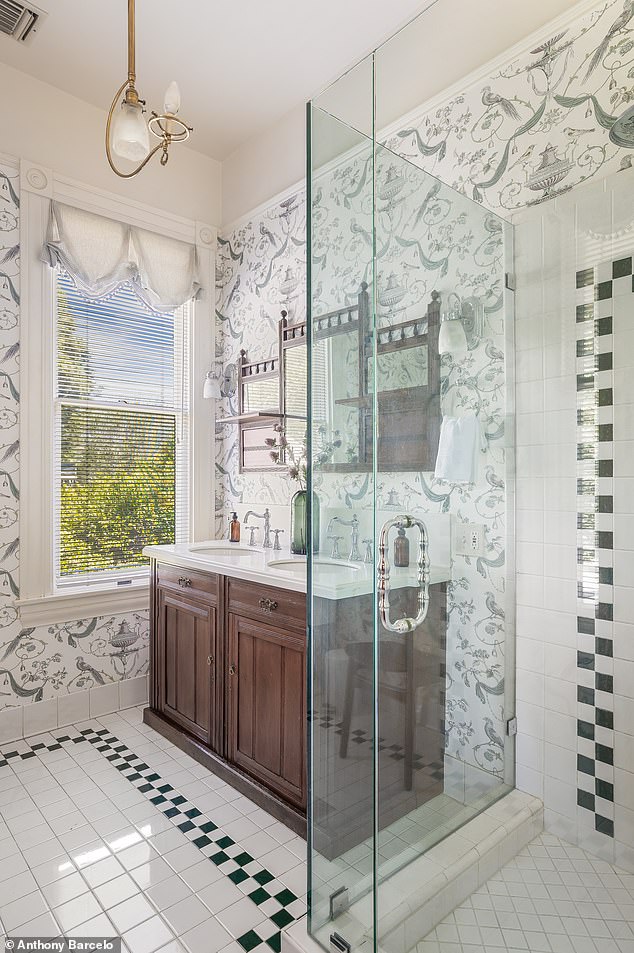 Primary bathroom with updated fixtures and spa-style glass shower