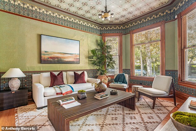 Sunlit parlor with wraparound windows and garden views