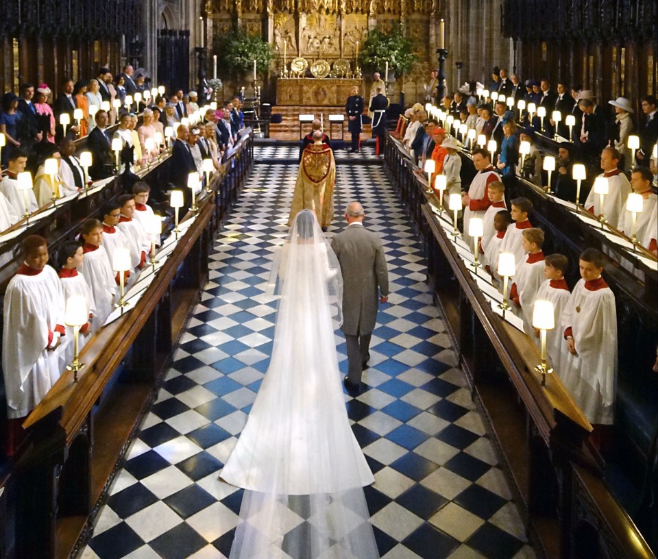 Meghan Markle and Prince Charles walking down the aisle at St. George's Chapel.