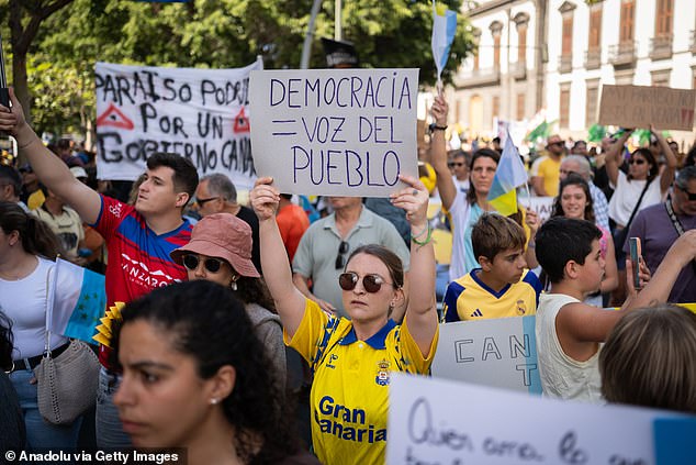 A placards in Spanish said: 'Don't sell your homes to guiris!' Guiri is a Spanish slang word for British and other tourists