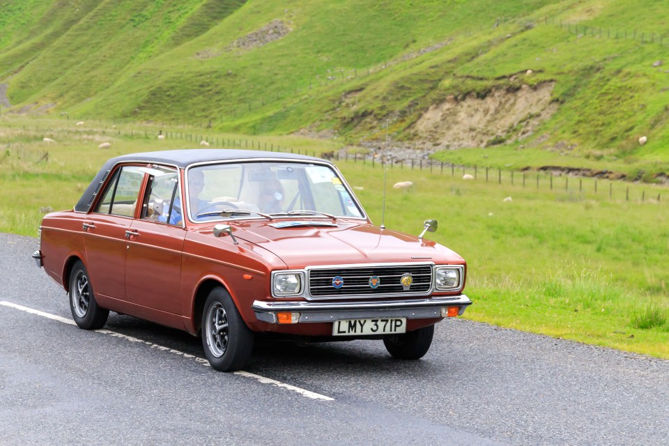 1975 Hillman Hunter Topaz saloon car driving on a road.
