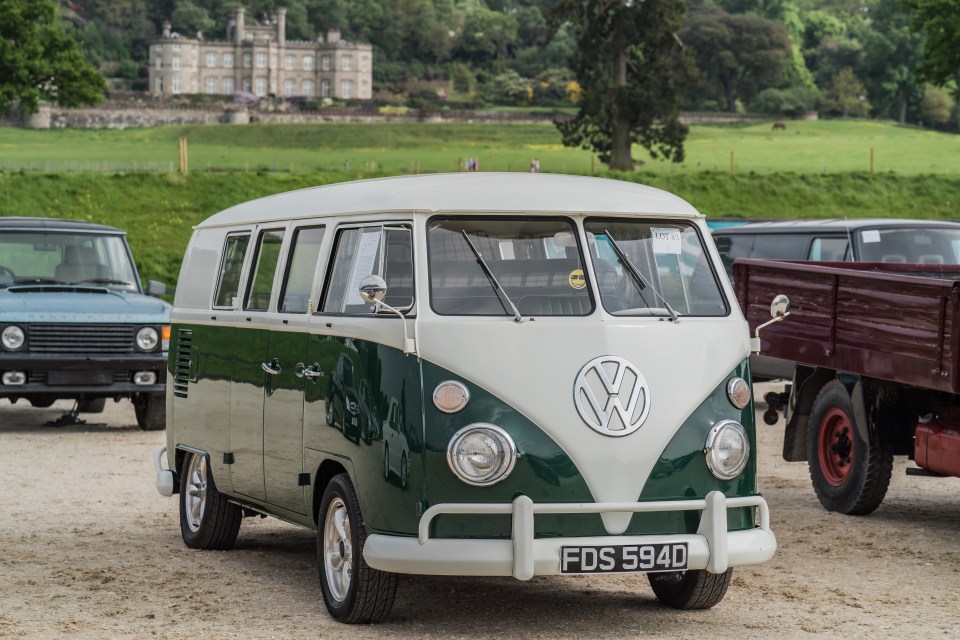 Two-tone green and white Volkswagen Type 2 van at a classic car auction.