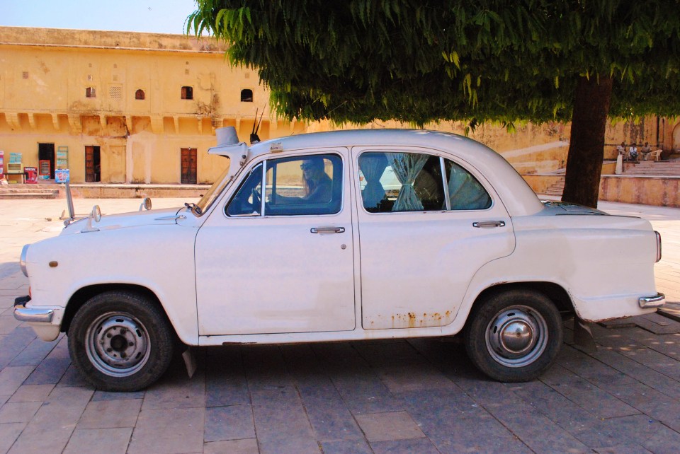 White Hindustan Ambassador car parked at Amber Fort, Jaipur.