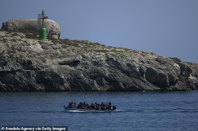 A boat with migrants seen under the lighthouse in Lampedusa, Italy on August 4, 2022